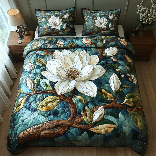 Magnolia Whisper quilted 3-piece bedding set on a made bed with two matching pillow shams