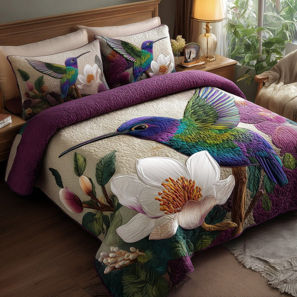 Magnolia Whispers quilted 3-piece bedding set on a made bed with two matching pillow shams