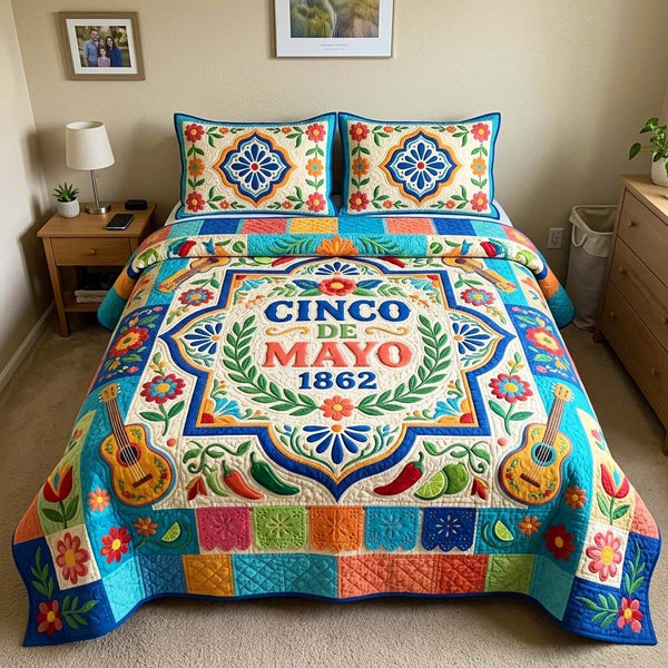 Mayo Crest quilted 3-piece bedding set on a made bed with two matching pillow shams