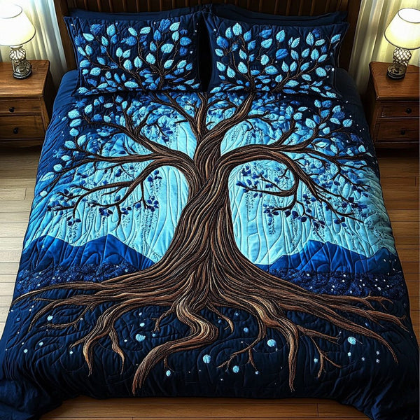 Midnight Blue Tree quilted 3-piece bedding set on a made bed with two matching pillow shams