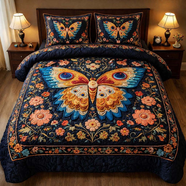 Midnight Butterfly Bloom quilted 3-piece bedding set on a made bed with two matching pillow shams