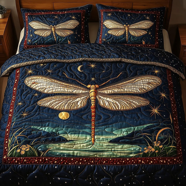 Midnight Dragonfly quilted 3-piece bedding set on a made bed with two matching pillow shams