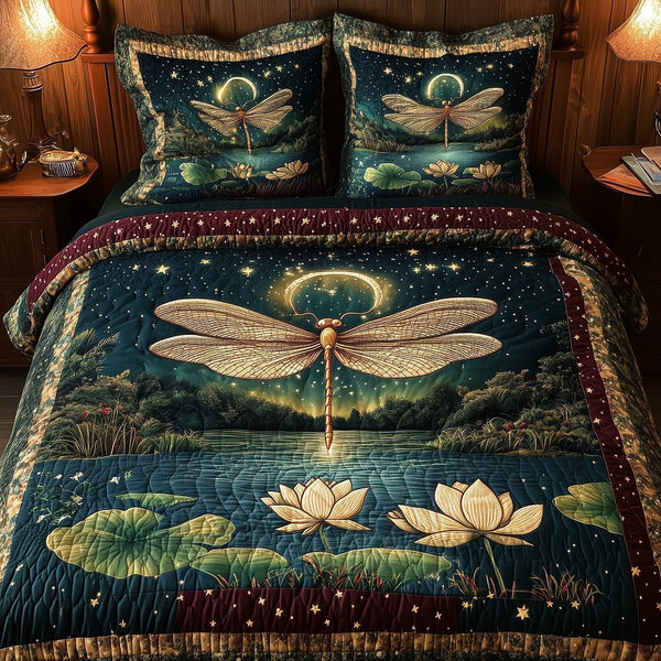 Midnight Dragonfly quilted 3-piece bedding set on a made bed with two matching pillow shams