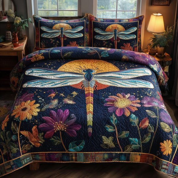 Midnight Dragonfly quilted 3-piece bedding set on a made bed with two matching pillow shams