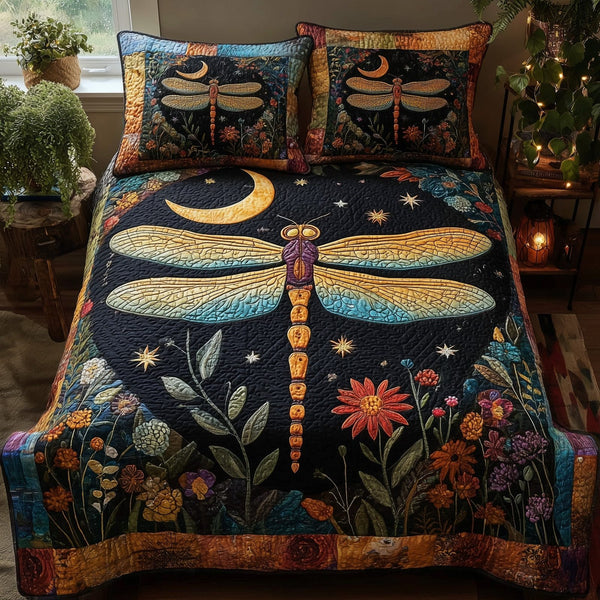 Midnight Dragonfly quilted 3-piece bedding set on a made bed with two matching pillow shams