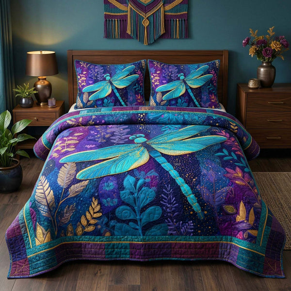 Midnight Dragonfly quilted 3-piece bedding set on a made bed with two matching pillow shams
