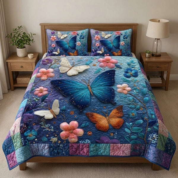 Midnight Flutter quilted 3-piece bedding set on a made bed with two matching pillow shams