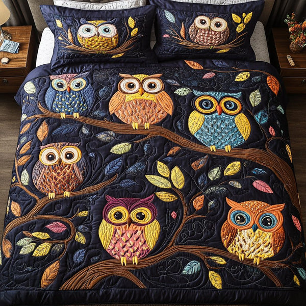 Midnight Owls quilted 3-piece bedding set on a made bed with two matching pillow shams