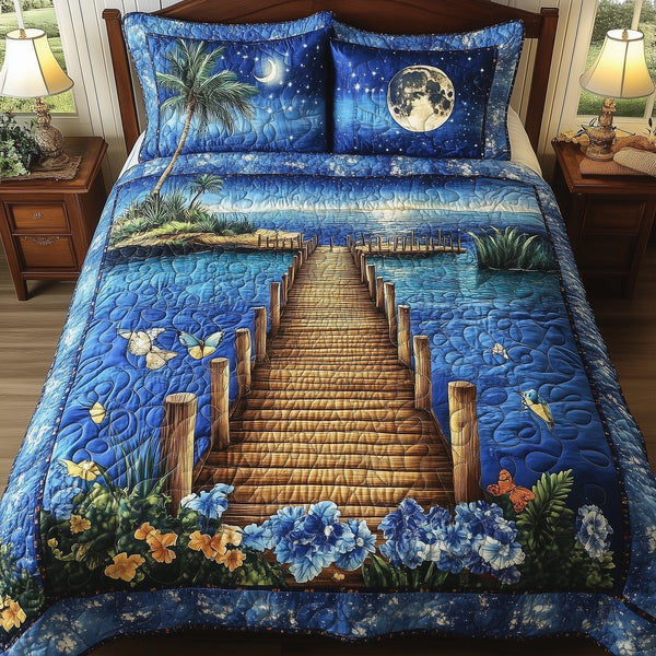 Midnight Tidewalk quilted 3-piece bedding set on a made bed with two matching pillow shams