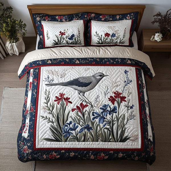 Mockingbird Haven quilted 3-piece bedding set on a made bed with two matching pillow shams