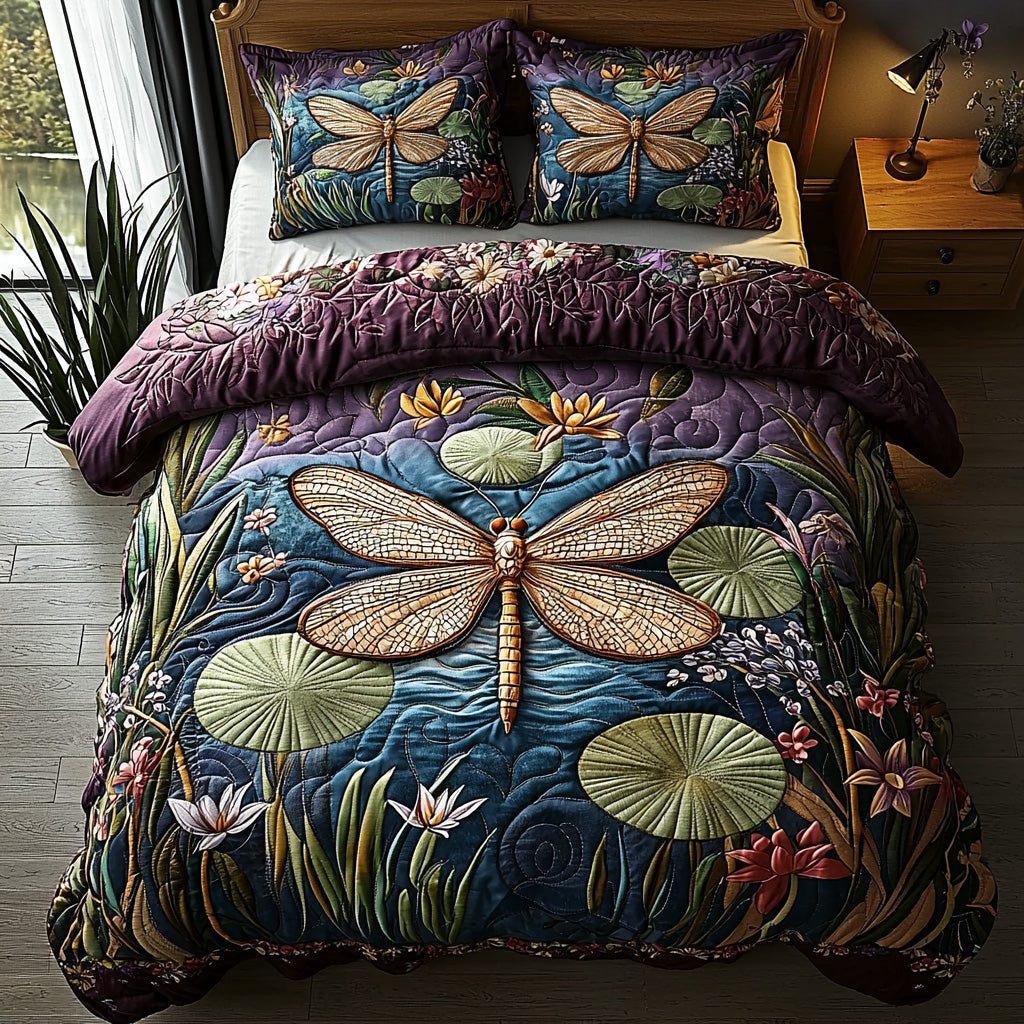 Moonlit Dragonfly quilted 3-piece bedding set on a made bed with two matching pillow shams