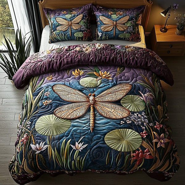 Moonlit Dragonfly quilted 3-piece bedding set on a made bed with two matching pillow shams