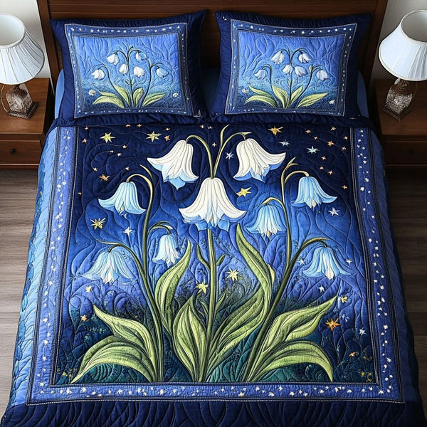 Moonlit Flowers quilted 3-piece bedding set on a made bed with two matching pillow shams