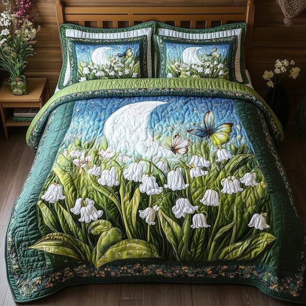 Moonlit Lily quilted 3-piece bedding set on a made bed with two matching pillow shams