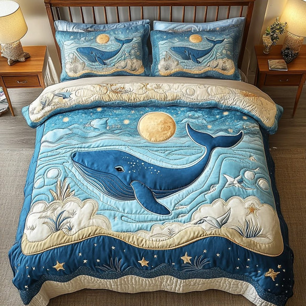 Moonlit Ocean Whale quilted 3-piece bedding set on a made bed in a light coastal bedroom