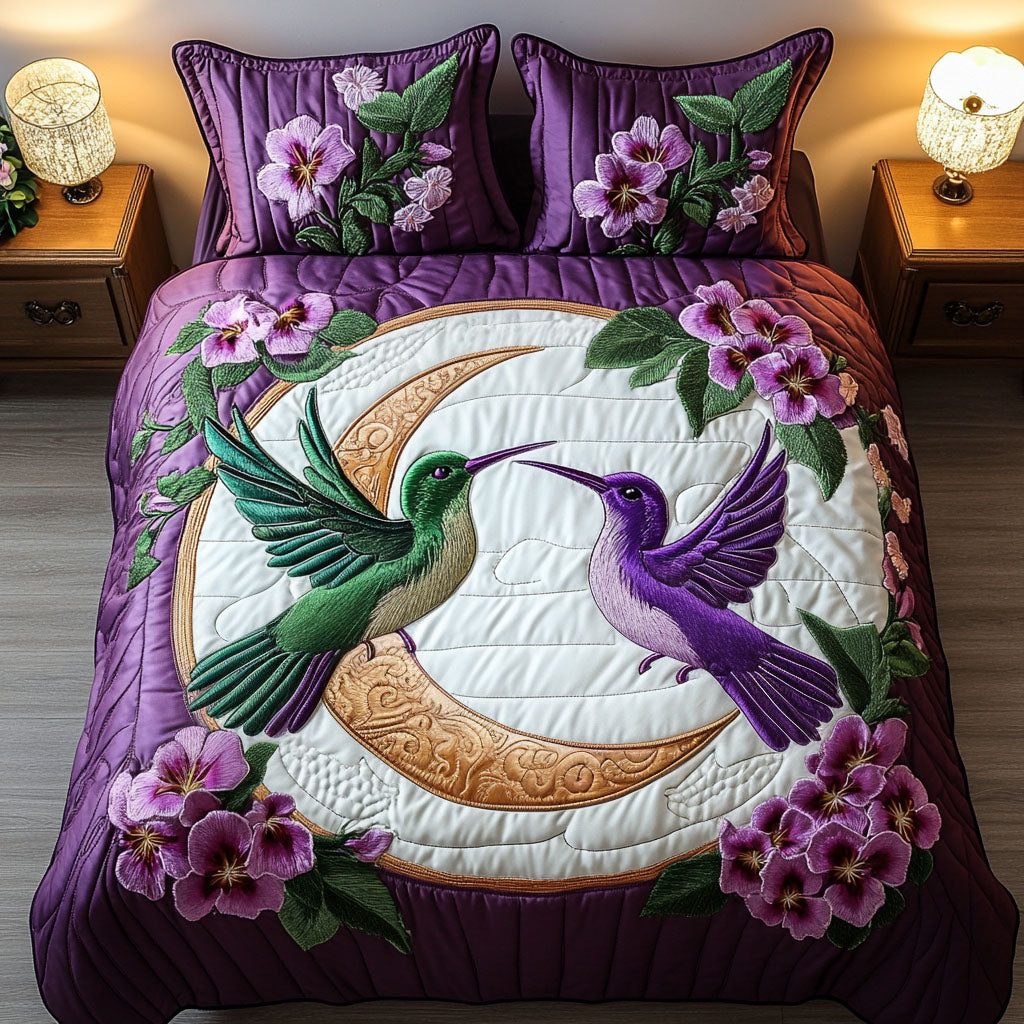 Moonlit Romance quilted 3-piece bedding set on a made bed with two matching pillow shams