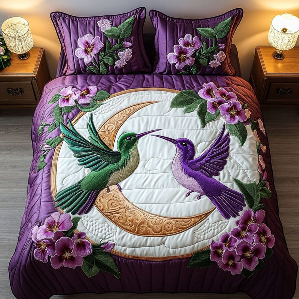 Moonlit Romance quilted 3-piece bedding set on a made bed with two matching pillow shams