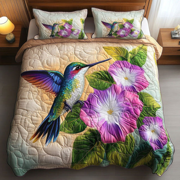Morning Glory Flight quilted 3-piece bedding set on a made bed with two matching pillow shams