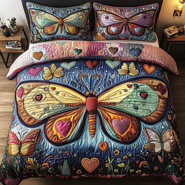 Moth Magic quilted 3-piece bedding set on a made bed with two matching pillow shams