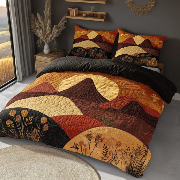 Mountain Sunset quilted 3-piece bedding set on a made bed with two matching pillow shams