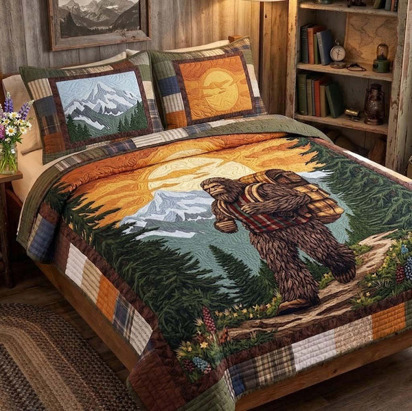 Mountain Tracker quilted 3-piece bedding set on a made bed with two matching pillow shams