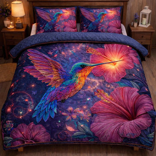 Mystic Glow Hummingbird quilted 3-piece bedding set on a made bed with two matching pillow shams