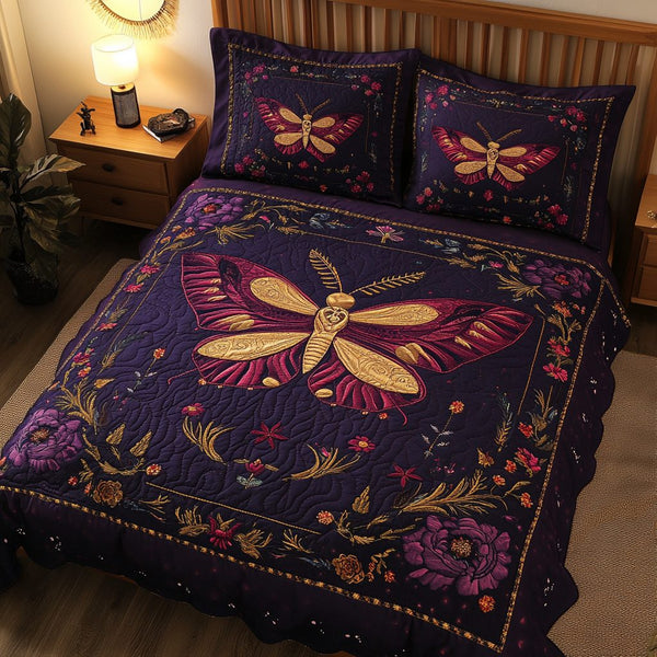 Mystic Moth quilted 3-piece bedding set on a made bed with two matching pillow shams