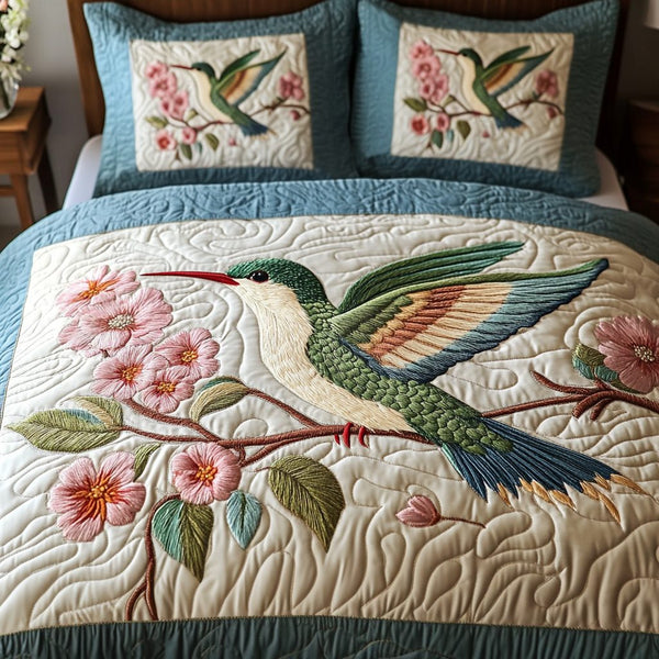 Nature Whispers quilted 3-piece bedding set on a made bed with two matching pillow shams