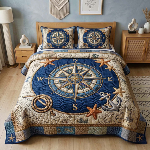 Nautical Compass quilted 3-piece bedding set on a made bed in a light coastal bedroom