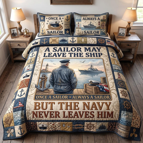 Navy Legacy quilted 3-piece bedding set on a made bed in a warmly lit bedroom