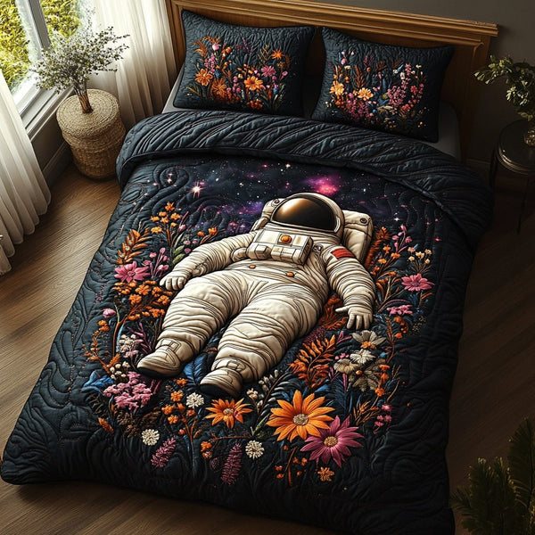 Nebula Navigator quilted 3-piece bedding set on a made bed with two matching pillow shams