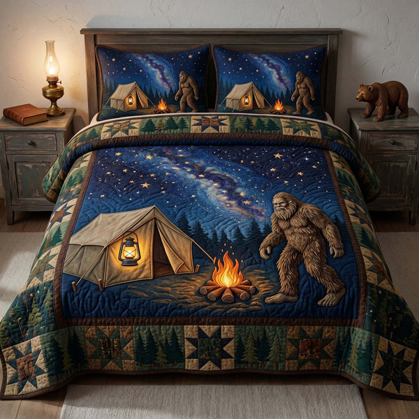 Night Camp Bigfoot quilted 3-piece bedding set on a made bed with two matching pillow shams