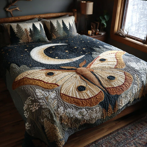 Night Moth quilted 3-piece bedding set on a made bed with two matching pillow shams