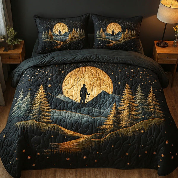 Nomad Nights quilted 3-piece bedding set on a made bed with two matching pillow shams