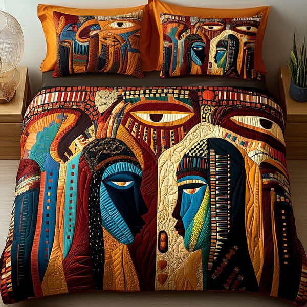 Nubian Queen quilted 3-piece bedding set on a made bed with two matching pillow shams