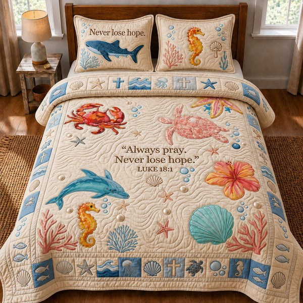 Ocean Bible Quote quilted 3-piece bedding set on a made bed in a softly lit bedroom