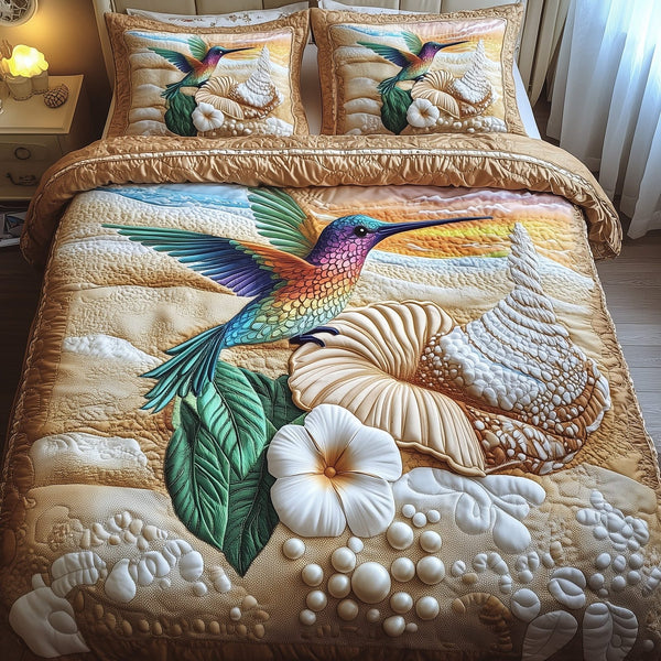 Ocean Breeze Hummingbird quilted 3-piece bedding set on a made bed in a light coastal bedroom