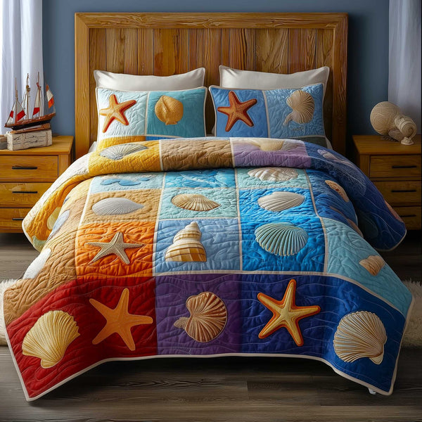 Ocean Breeze quilted 3-piece bedding set on a made bed in a light coastal bedroom