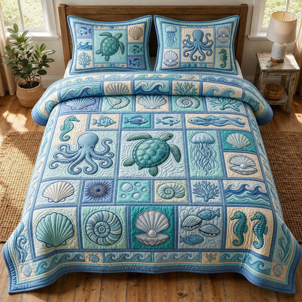 Ocean Creatures quilted 3-piece bedding set on a made bed in a light coastal bedroom