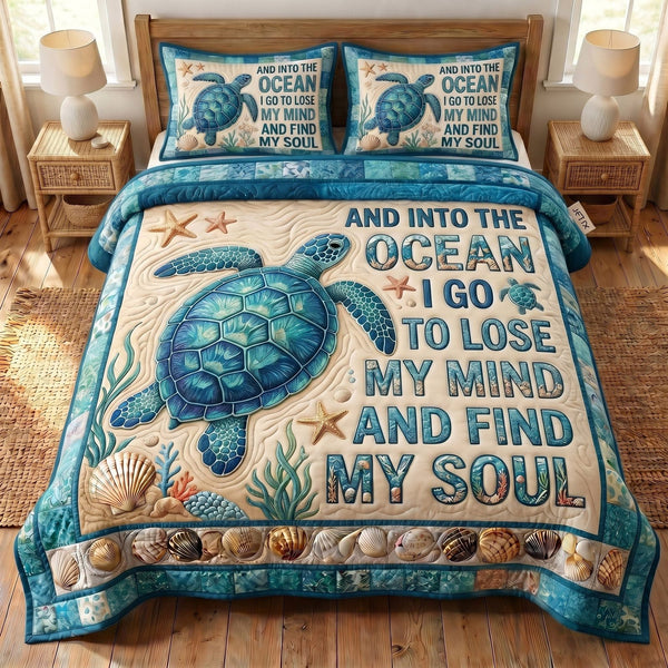 Ocean Escape quilted 3-piece bedding set on a made bed in a light coastal bedroom