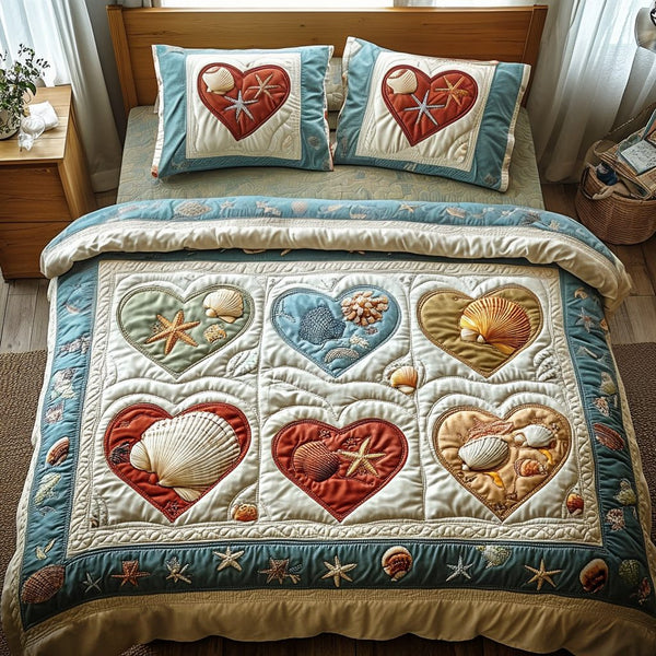Ocean Hearts quilted 3-piece bedding set on a made bed in a light coastal bedroom
