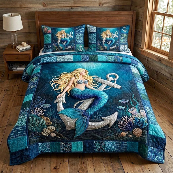 Ocean Siren quilted 3-piece bedding set on a made bed in a light coastal bedroom