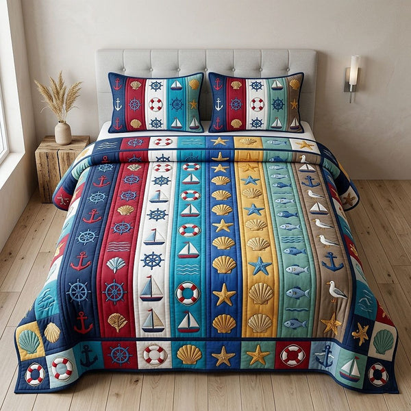 Ocean Voyage quilted 3-piece bedding set on a made bed in a light coastal bedroom