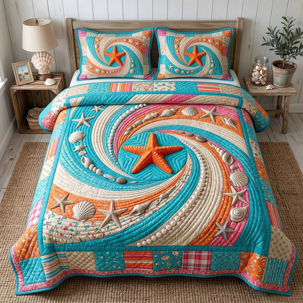 Ocean Whirl quilted 3-piece bedding set on a made bed in a light coastal bedroom