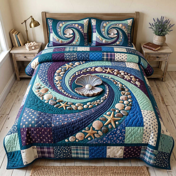Ocean Whirl quilted 3-piece bedding set on a made bed in a light coastal bedroom