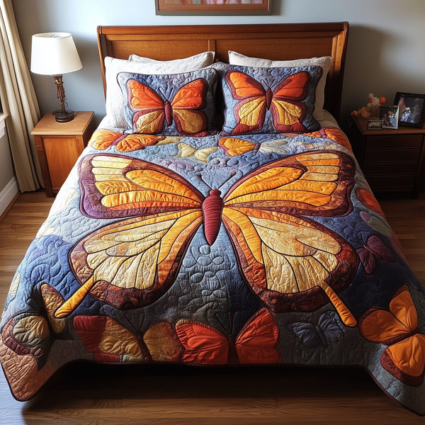 Orange Butterflies quilted 3-piece bedding set on a made bed with two matching pillow shams