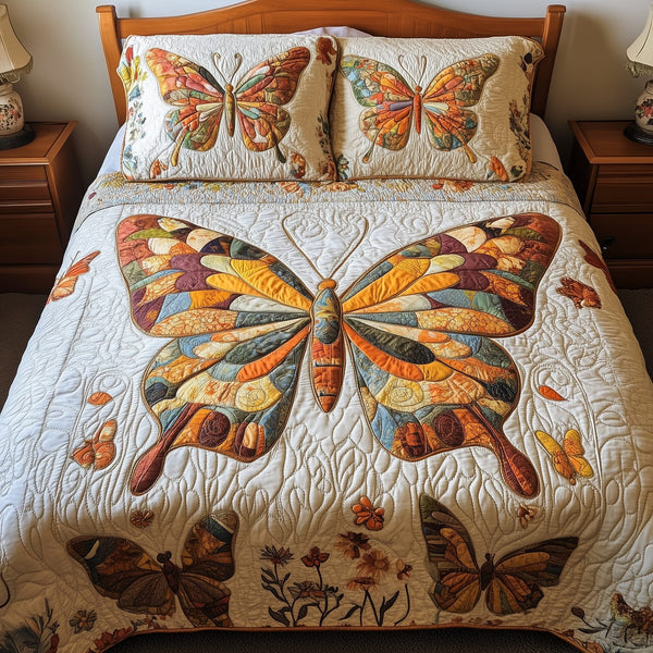 Orange Butterflies quilted 3-piece bedding set on a made bed with two matching pillow shams