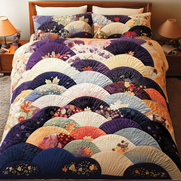 Orchid Fans quilted 3-piece bedding set on a made bed with two matching pillow shams