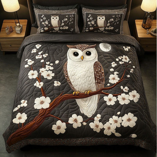 Owl Blossom quilted 3-piece bedding set on a made bed with two matching pillow shams