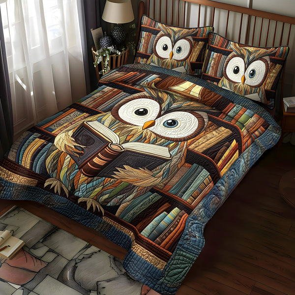 Owl Literary Flight quilted 3-piece bedding set on a made bed with two matching pillow shams